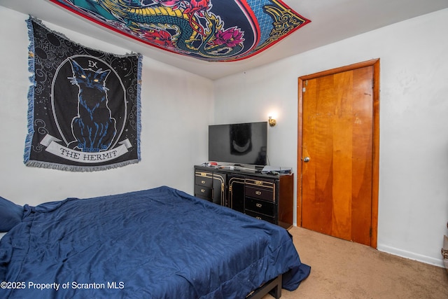 bedroom featuring baseboards and carpet