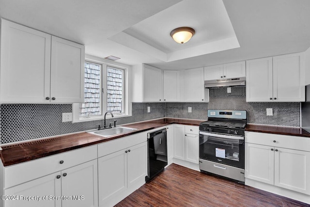 kitchen with a raised ceiling, sink, black dishwasher, stainless steel range, and white cabinetry