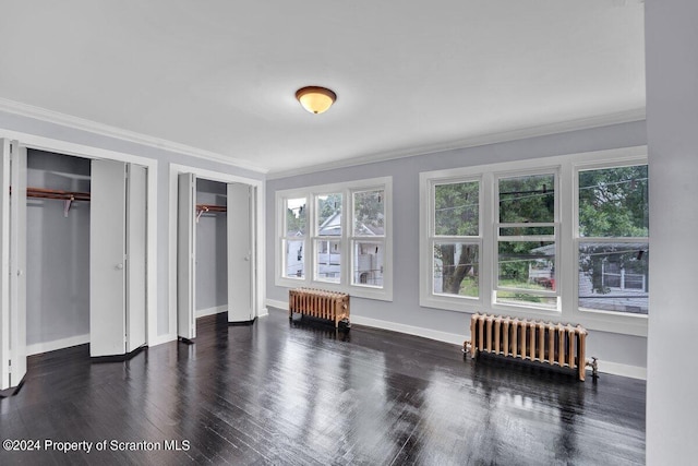 bedroom featuring multiple closets, crown molding, radiator heating unit, and dark wood-type flooring