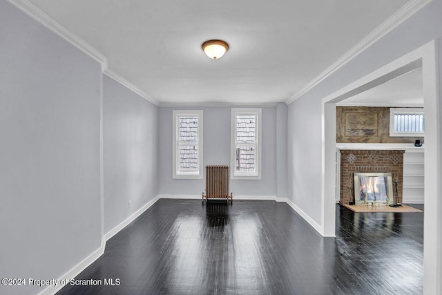 unfurnished living room featuring a fireplace, dark hardwood / wood-style flooring, radiator heating unit, and crown molding