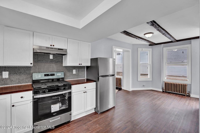 kitchen featuring beam ceiling, radiator heating unit, white cabinetry, and appliances with stainless steel finishes