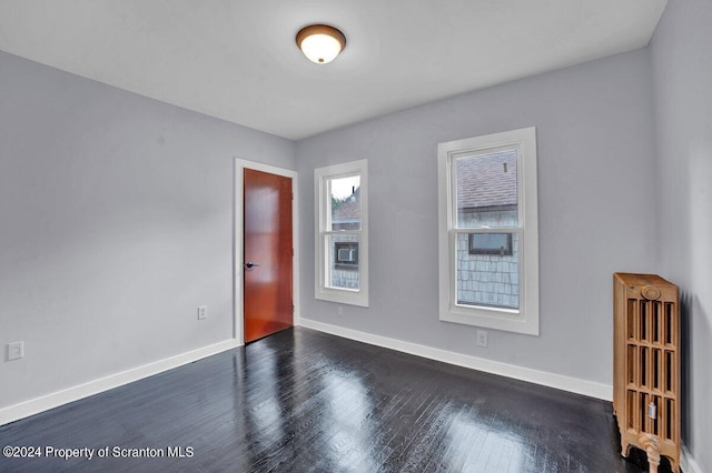 spare room with dark hardwood / wood-style floors