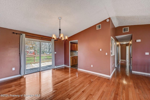 unfurnished dining area with a textured ceiling, light wood-style flooring, visible vents, a chandelier, and vaulted ceiling