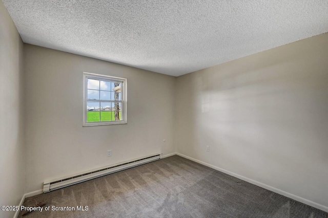 spare room with a baseboard heating unit, a textured ceiling, carpet, and baseboards