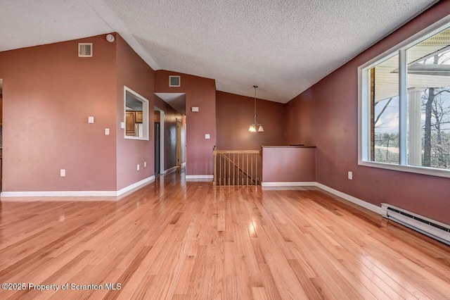 unfurnished room featuring lofted ceiling, visible vents, and light wood-style flooring