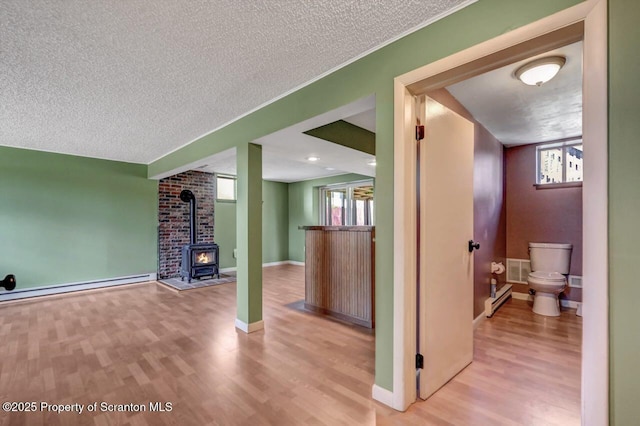 interior space featuring a wealth of natural light, wood finished floors, visible vents, and a textured ceiling