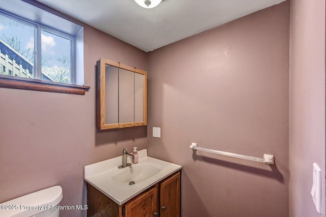 bathroom featuring vanity and toilet