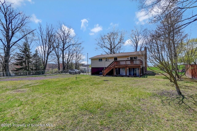 back of property with fence, stairway, a deck, and a chimney