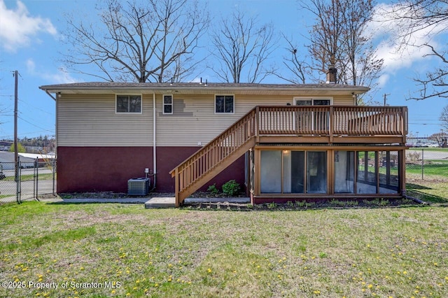 back of property with a wooden deck, stairway, central AC unit, a lawn, and fence