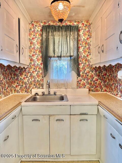 kitchen featuring white cabinets and sink