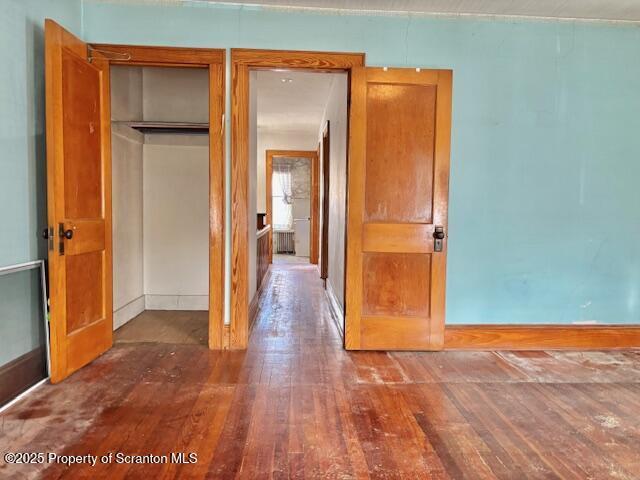 unfurnished room with dark wood-type flooring