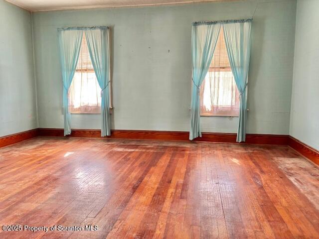 empty room with hardwood / wood-style flooring