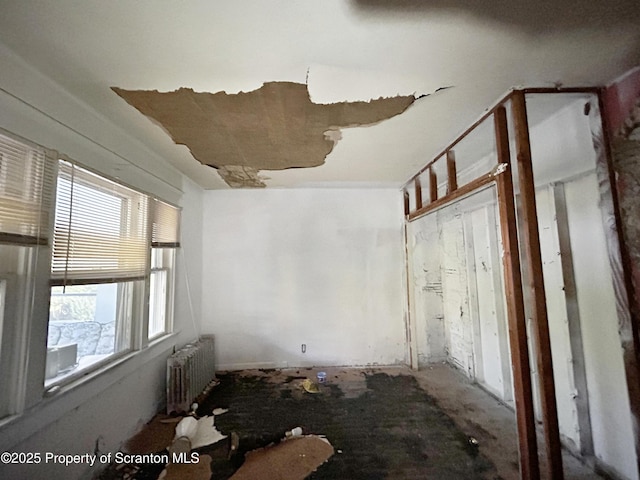 spare room featuring radiator heating unit