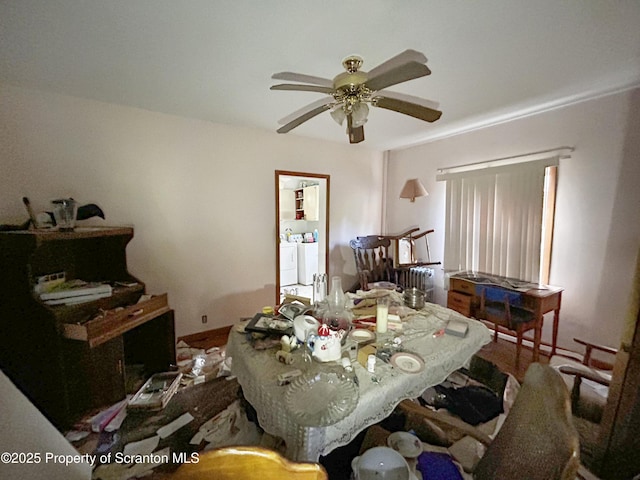 bedroom with independent washer and dryer and a ceiling fan