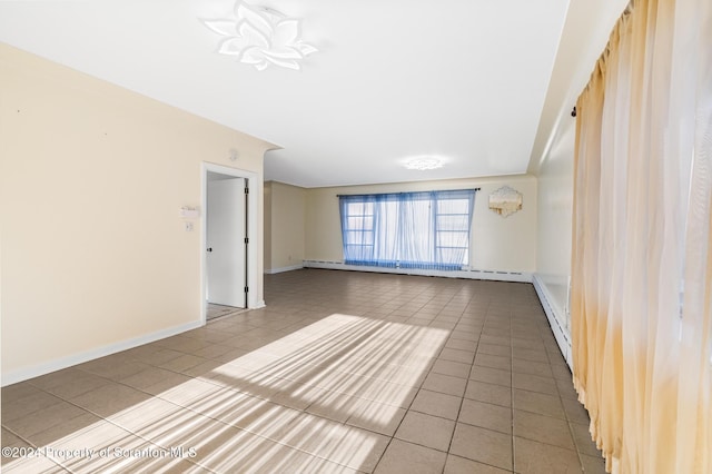 tiled spare room with baseboard heating