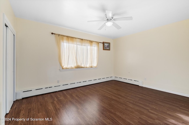 empty room with baseboard heating, ceiling fan, and dark wood-type flooring