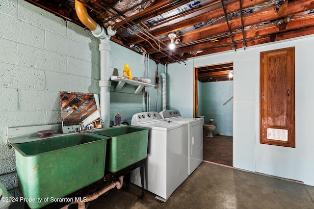 clothes washing area featuring washing machine and dryer and sink