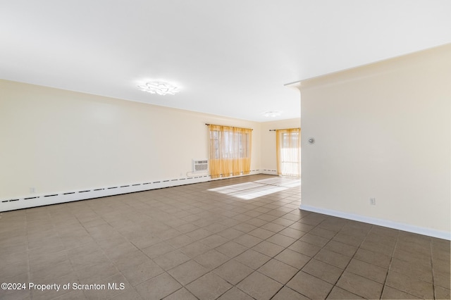 tiled spare room with a baseboard radiator