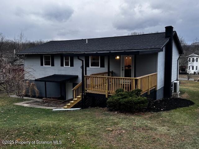 back of house featuring a deck, a yard, and central AC