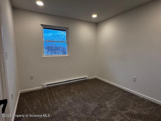 carpeted empty room with baseboard heating