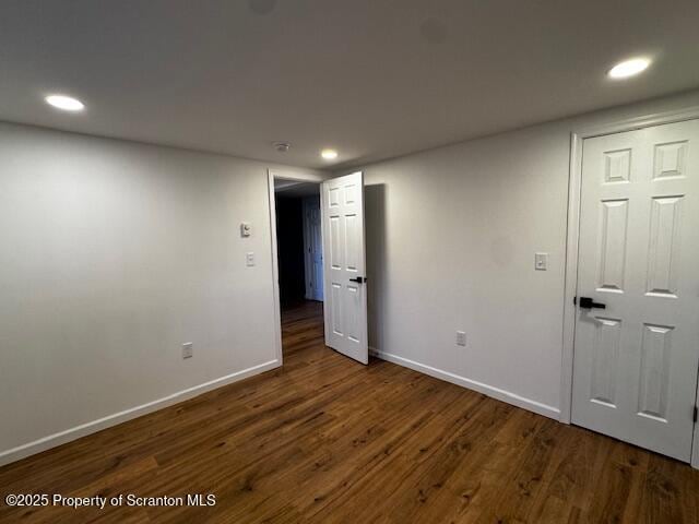 spare room with dark hardwood / wood-style floors