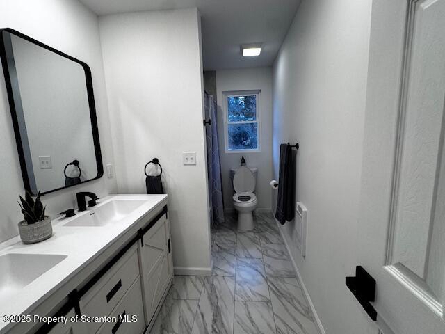 bathroom featuring vanity and toilet