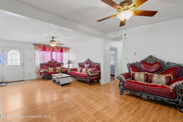 living room with hardwood / wood-style flooring, plenty of natural light, and ceiling fan