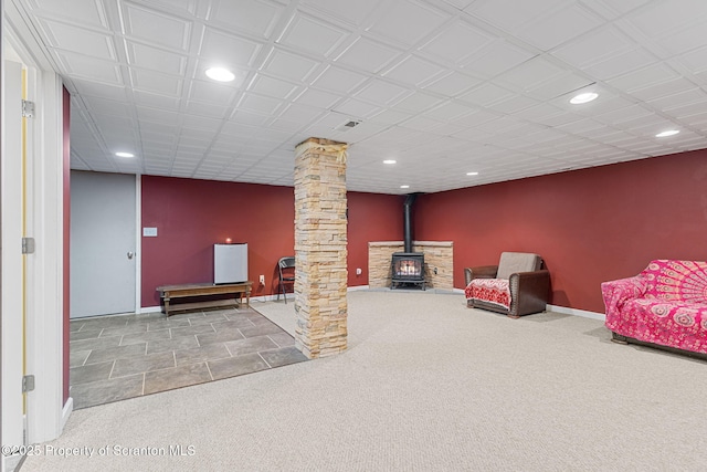 interior space featuring ornate columns and a wood stove