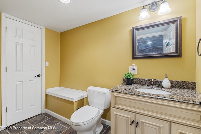 bathroom with toilet and vanity