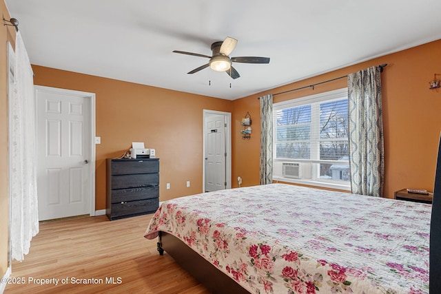 bedroom with ceiling fan and light hardwood / wood-style flooring