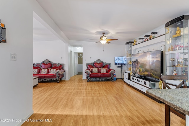 living room with ceiling fan and wood-type flooring