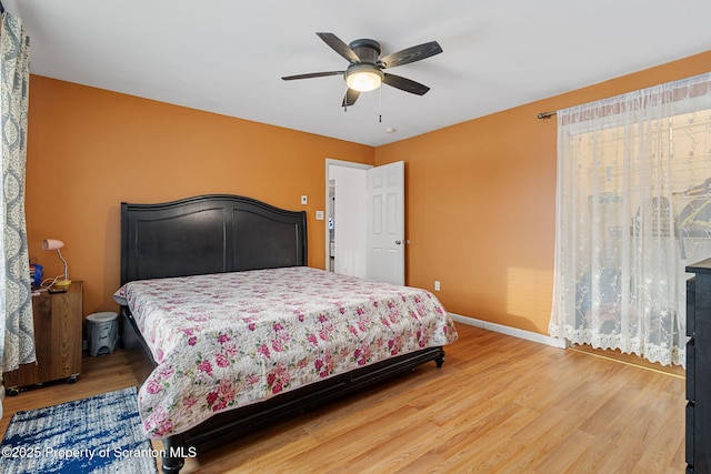 bedroom with ceiling fan and hardwood / wood-style floors