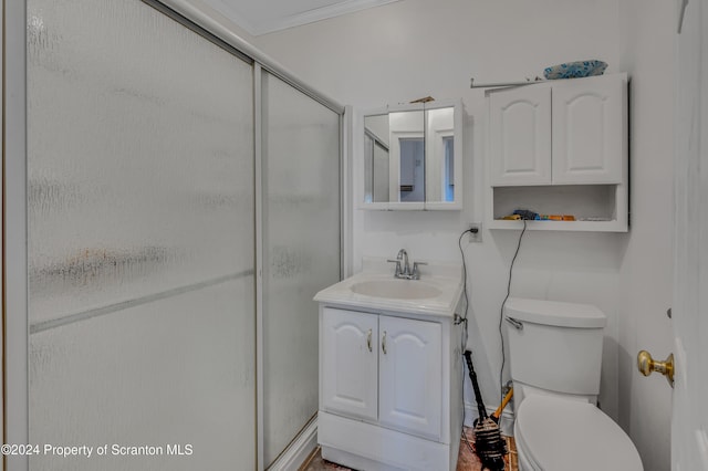 bathroom with vanity, toilet, walk in shower, and crown molding