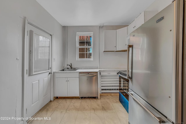 kitchen with white cabinetry, sink, and appliances with stainless steel finishes