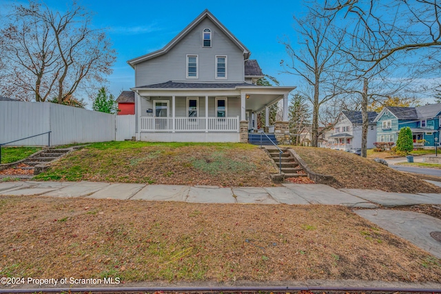 view of front of house featuring a porch and a front yard