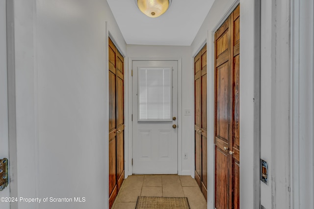 hall with light tile patterned floors