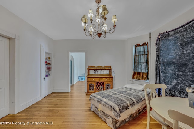 bedroom featuring a notable chandelier and light hardwood / wood-style flooring