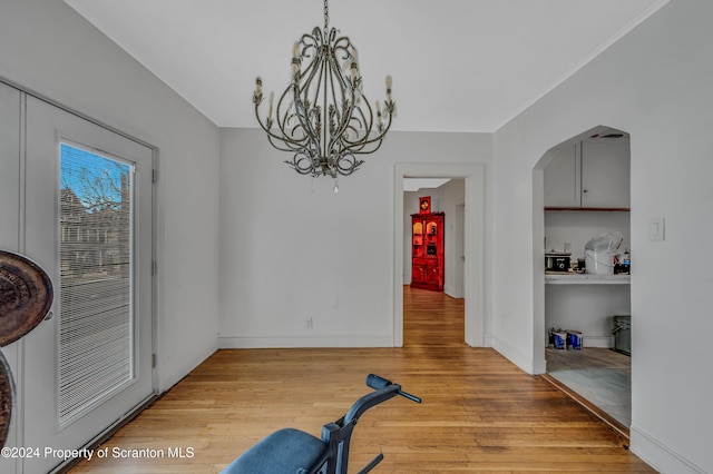 dining space with light hardwood / wood-style flooring and an inviting chandelier