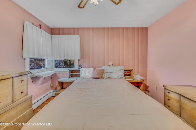 bedroom with ceiling fan and a baseboard radiator