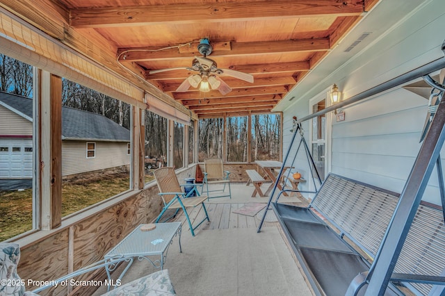 sunroom / solarium with ceiling fan and beam ceiling