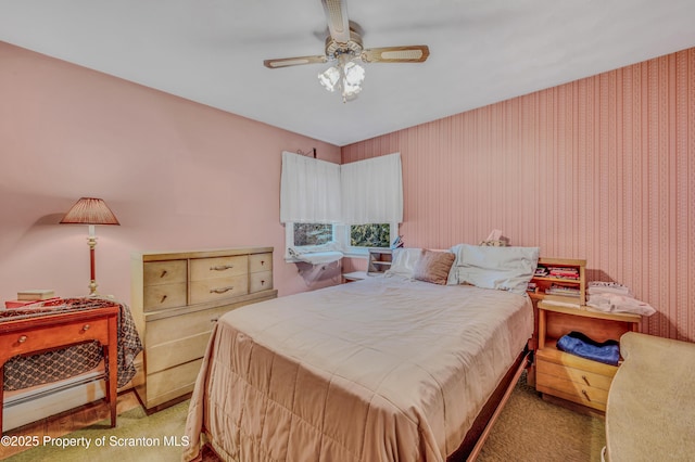 bedroom featuring carpet floors, a baseboard radiator, and ceiling fan