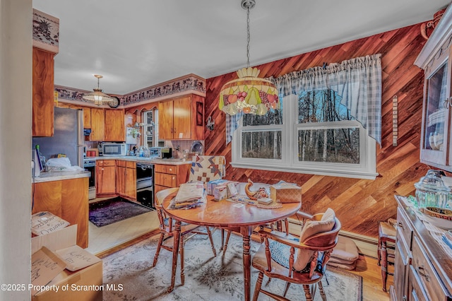 dining room featuring wooden walls