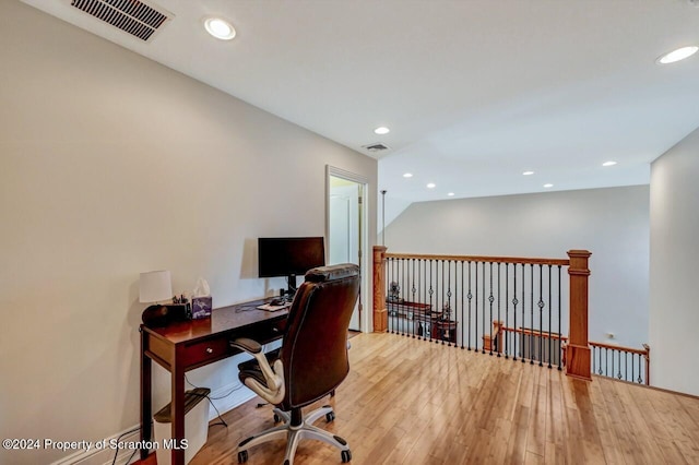 office space with wood-type flooring