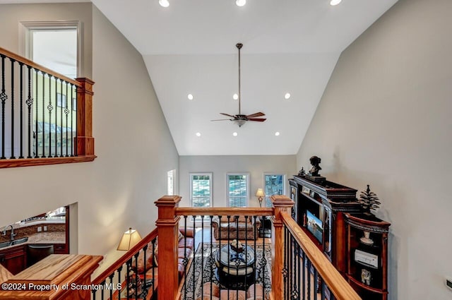 corridor with sink and high vaulted ceiling