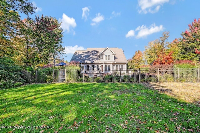 back of house featuring a lawn