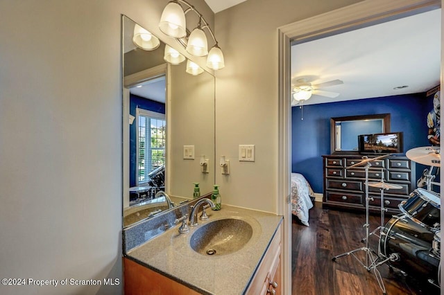 bathroom with ceiling fan, vanity, and hardwood / wood-style flooring