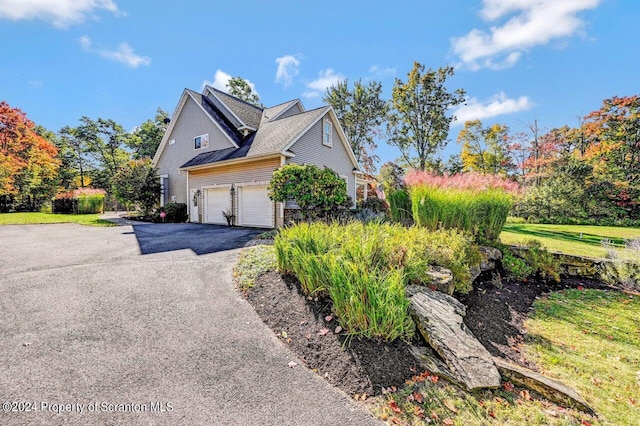 view of side of property featuring a garage