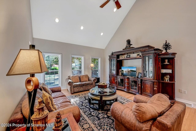 living room featuring high vaulted ceiling, light hardwood / wood-style flooring, and ceiling fan