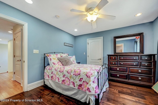 bedroom with ceiling fan and dark hardwood / wood-style floors