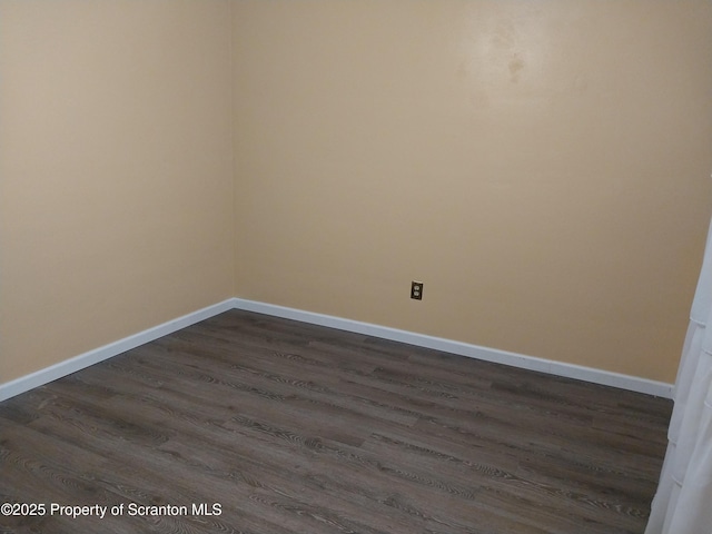 unfurnished room featuring dark wood-type flooring